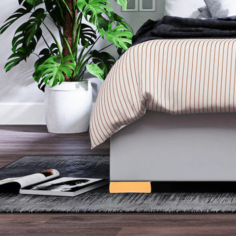 Four Pack Silicone Furniture Stoppers With Antislip Design under bed on hardwood floor