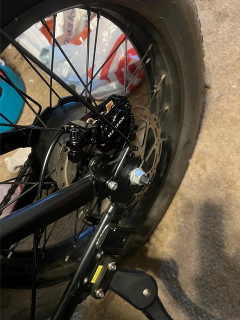 Four Piston Hydraulic Disc Brake Replacement Kit For X1S E Bike Upgrade, installed on rear wheel for safer stops