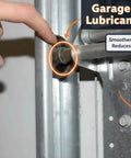 Hand applying Heavy Duty Garage Door Lubricant 20 Oz to rollers, highlighting smoother and quieter operation