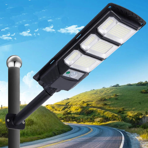 JUDYSSY Outdoor Waterproof Solar Street Light Led Wall Light, Outdoor Dusk to Dawn Solar Flood Light mounted on pole near scenic road.