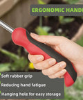 Close-up of hand holding the Two Prong Weed Puller Tool With Soft Grip Handle Stainless Steel Dandelion Weeder in a garden