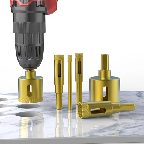 Heavy Duty Three Piece Diamond Drill Bit Hole Saw Kit For Smashing Through Ceramic Tile Granite Marble And Glass Bottles Without Breakage Plus Knockout Cutting Power Measures Two Fifth To Four Fifth Inches Wide on a marble surface