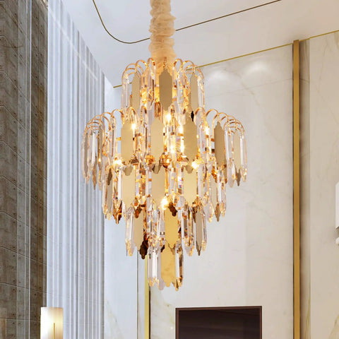 Lit Gold Finish Modern Crystal Chandelier, 5-Tier 7-Light Round Pendant Ceiling Light with adjustable chain in a living room setting
