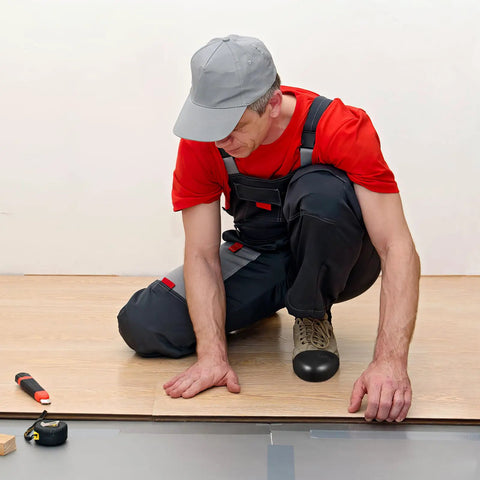 Worker wearing durable safety toe guards for shoes on a construction site, showing steel toe cap covers for injury prevention.
