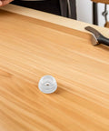 Single silicone anti slip furniture pad for couch and chair legs on wooden surface, soft yet durable rubber feet protector