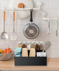 Acrylic Coffee Station Organizer for Countertops and Coffee Bars with 4 Compartments holding cups and packets, black finish.