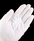 Gloved hand holding 50 Pack Plastic Gears With 9 Teeth Model 092A Worm Gear Set For RC Cars And Robot Motors 5.5mm Outer Diameter