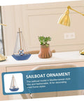 Mediterranean Wooden Sailboat Model Decor for Home and Office Cozy Cottage Nautical Vibe Ornament on a desk with lamp and plant