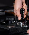 Close-up of 58Mm Espresso Tool Kit 6 In 1 with tamper on silicone mat for even grounds and consistent espresso