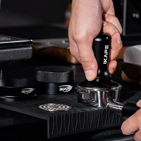 Close-up of 58Mm Espresso Tool Kit 6 In 1 with tamper on silicone mat for even grounds and consistent espresso
