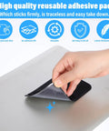 Hand peels Stick On Dual Pocket SSD Carrying Case with Reusable Adhesive for Laptops and External Drives from surface.