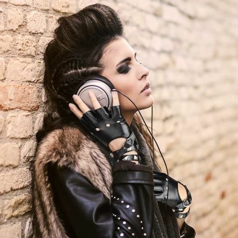Womens Dope Edgy Punk Fingerless Leather Gloves Featuring Chill Ride Ready PU Half Finger Design With Grippy Wrist Wrap For Motoring Night Rides And Casual Hangout Wear worn by a woman listening to music.