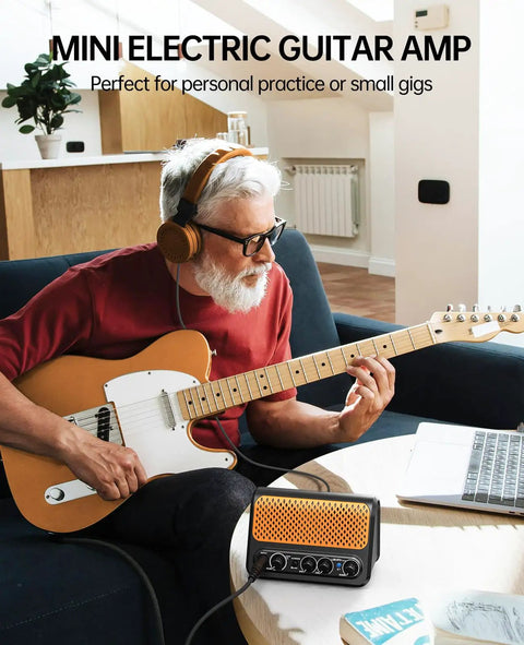 Man using 10W Mini Electric Guitar Amplifier With Clean And Overdrive Channels, Reverb, Bluetooth Streaming, Dual Small Speakers, Black And Orange.