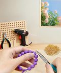 DIY jewelry crafting with 800Pcs Screw Eye Pins Kit For Jewelry Making And DIY Crafts, pliers and beads, purple bracelet assembly
