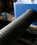 Close-up of textured handle of Pro Grade Power Drill Wire Puller With Heavy Duty Steel Body And Twenty Meter Fish Tape Included For Fast Track Conduit Threading No Sweat Cable Installation On Any Project Site.