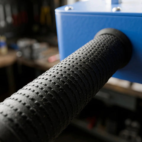 Close-up of textured handle of Pro Grade Power Drill Wire Puller With Heavy Duty Steel Body And Twenty Meter Fish Tape Included For Fast Track Conduit Threading No Sweat Cable Installation On Any Project Site.