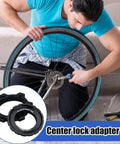 Person using Beefy Center Lock Bike Rotor Tool for upgrading ride, black aluminum adapters visible, cycling focus.