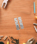 Two Pairs Stainless Steel Pivot Hinges, 360 Degree Rotatable Concealed Door Hinges on a wooden surface with tools