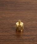 Professional Grade Beefy Brass Refrigeration Valve Caps With Slick Knurled Nozzles For Ac Systems And Coolant Lines Leak Proof Field Service Covers No Sweat Maintenance 30 Pack brass valve cap on wooden surface.