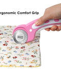 Person using pink 45mm rotary cutter set with 5 extra blades for fabric leather crafting sewing and quilting ergonomic grip