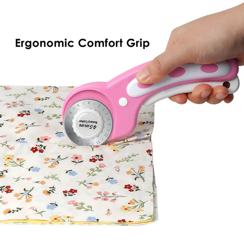 Person using pink 45mm rotary cutter set with 5 extra blades for fabric leather crafting sewing and quilting ergonomic grip