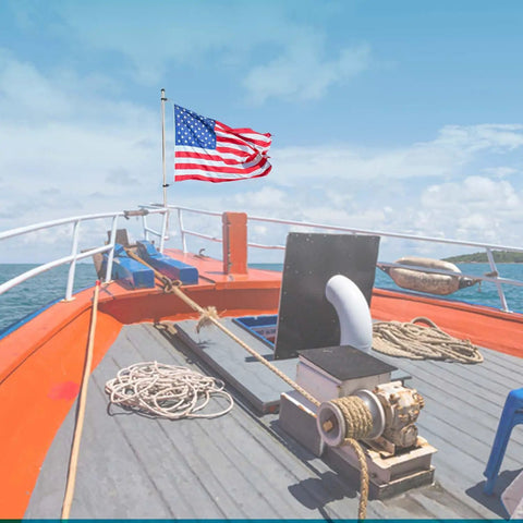 Rail Mount Flag Pole Base Set With 12 By 18 Inch American Flag on a boat deck, showcasing polished 304 stainless steel mount.