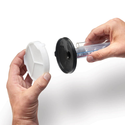 Hands holding the lid and filter of a Professional HEA Airless Paint Sprayer for easy assembly and maintenance.