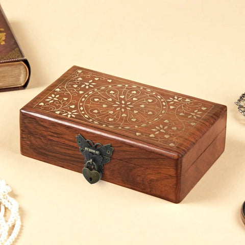 Retro Engraved Jewelry Box with heart-shaped bronze hasp lock and intricate floral design, shown closed on a wooden table.