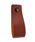 Leather Furniture Handles Set Two Pieces Cognac Leather Drawer Pulls For Cabinets Dressers Kitchen And Bathroom Wood Furniture Six And A Half Inch Length Featuring Durable Craftsmanship And Industrial Style Accents For Modern Homes; close-up front view showing texture and single screw hole