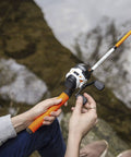 Person holding Roam Spincast Reel And Fishing Rod Combo, 6-Foot 2-Piece Fiberglass Rod With ComfortGrip Handle, by water