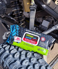 AutoSCRUB Cleaning Wipes Heavy Duty 60 Count Cleaning Cloths 15 By 10 Inches placed on off-road vehicle tire