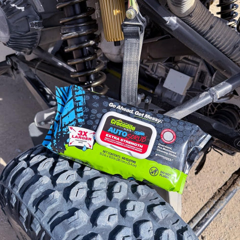AutoSCRUB Cleaning Wipes Heavy Duty 60 Count Cleaning Cloths 15 By 10 Inches placed on off-road vehicle tire