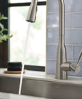 Top Shelf Stainless Steel Pull Down Kitchen Faucet Featuring One Handle High Arc Design With Fast Wash Power Boost And Smudge Resistant Matte Finish For Quick Cleanup And No Hassle Setup Plus Smooth Retractable Spray Hose Operation; water flowing gracefully from the faucet.