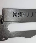 Neo Classical Cast Iron Mailbox With Swinging Letter Slot Door Wall Mounted Vintage Antique Postal Box Old School Charm, Ornate Garlands And Floral Accents, Reproduction Of 1900 Original With Weathered Iron Finish showing close-up of letter slot. 