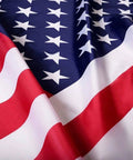 Close-up of 2x3 Indoor Outdoor US Flag Made From Polyester Nylon With Double Stitch Edges And Brass Grommets, vibrant red and blue colors.