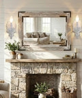 ZIRALIO Farmhouse Vintage Wall Sconce for Bedroom, 2-Pack, displayed beside a large mirror over a rustic stone fireplace.