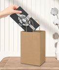 Hand placing gift into Bulk Brown Kraft Paper Bags With Handles 100 Pack Small Gift Bags 5.25 By 3.25 By 8.25 Inches Durable