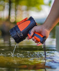 Hand holding Rechargeable Handheld Spotlight With Up To 4500 Lumens, IP67 Waterproof Marine Grade LED Searchlight over water
