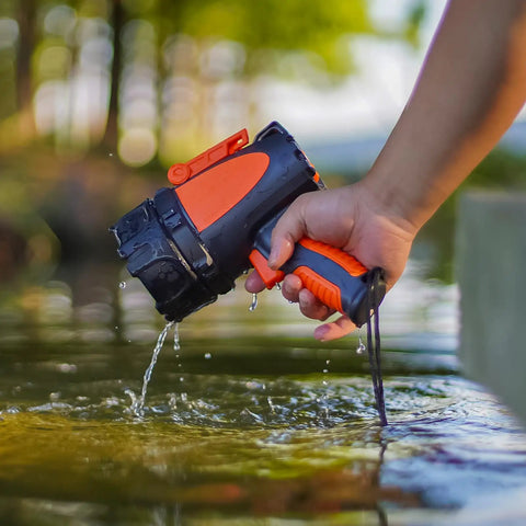 Hand holding Rechargeable Handheld Spotlight With Up To 4500 Lumens, IP67 Waterproof Marine Grade LED Searchlight over water