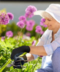 Woman gardening wearing nitrile coated work gloves with superior oil resistance and strong grip, ideal for everyday tasks.