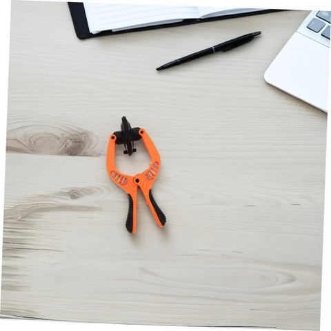 Phone Screen Repair Kit With Suction Cup Pliers For Quick Screen Opening on a desk beside a notebook and laptop