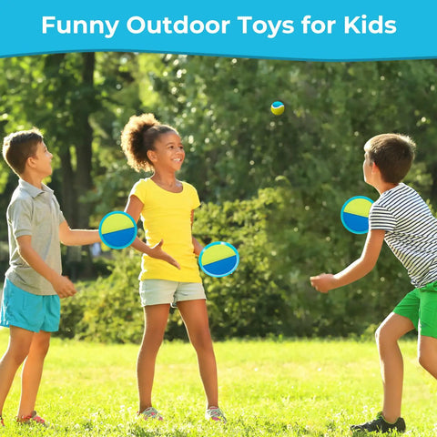 Children playing with an Outdoor Toss And Catch Ball Set For Kids Beach Toys And Backyard Games Perfect For Backyard Playgrounds And Beach Trips With 6 Balls And 3 Paddles Includes Storage Great Easter Gift Light Blue in a grassy area
