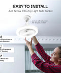 Person installing SocketAir Wireless Ceiling Fan Light With Remote Extender 110 To 120 Volts 2100 Lumens Three Fan Speeds Three Light Settings 6500K