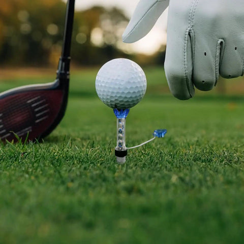 Golfer setting a ball on 80mm Magnetic Golf Tees 80 mm Long Unbreakable Plastic 4 Pack Blue Red Reusable Practice Tees For Men And Women Flexible Magnet Lift Step Design For Better Contact And Lower Ball Spin on grass