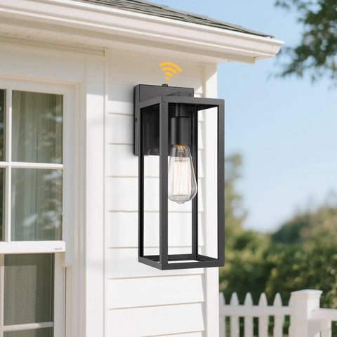 Dusk To Dawn Sensor Outdoor Wall Lantern With Black Finish Modern Wall Sconce mounted on a white exterior wall in daylight