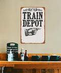 Train Depot Aluminum Wall Decor 12x8 Inch sign displayed above a shelf with cups and condiments, railroad station theme.