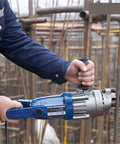 AOXHUGB Handheld Hydraulic Rebar Bender And Cutter Electric Shearing Machine being used to cut rebar on a construction site.