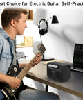 Musician using Guitar Mini Amp 5W Rechargeable Bluetooth Amplifier for desktop practice with clean and distortion channels.