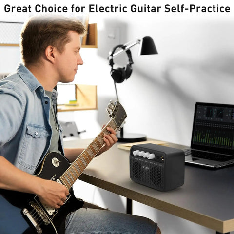 Musician using Guitar Mini Amp 5W Rechargeable Bluetooth Amplifier for desktop practice with clean and distortion channels.