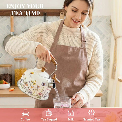 Woman pouring hot water from Stovetop Whistling Tea Kettle Two Point Seven Quart Floral Pattern Stainless Steel Tea Pot With Wood Pattern Handle Perfect For Boiling Water Coffee Or Milk Durable All Stovetop Kitchen Must Have For Real Essential into a glass.